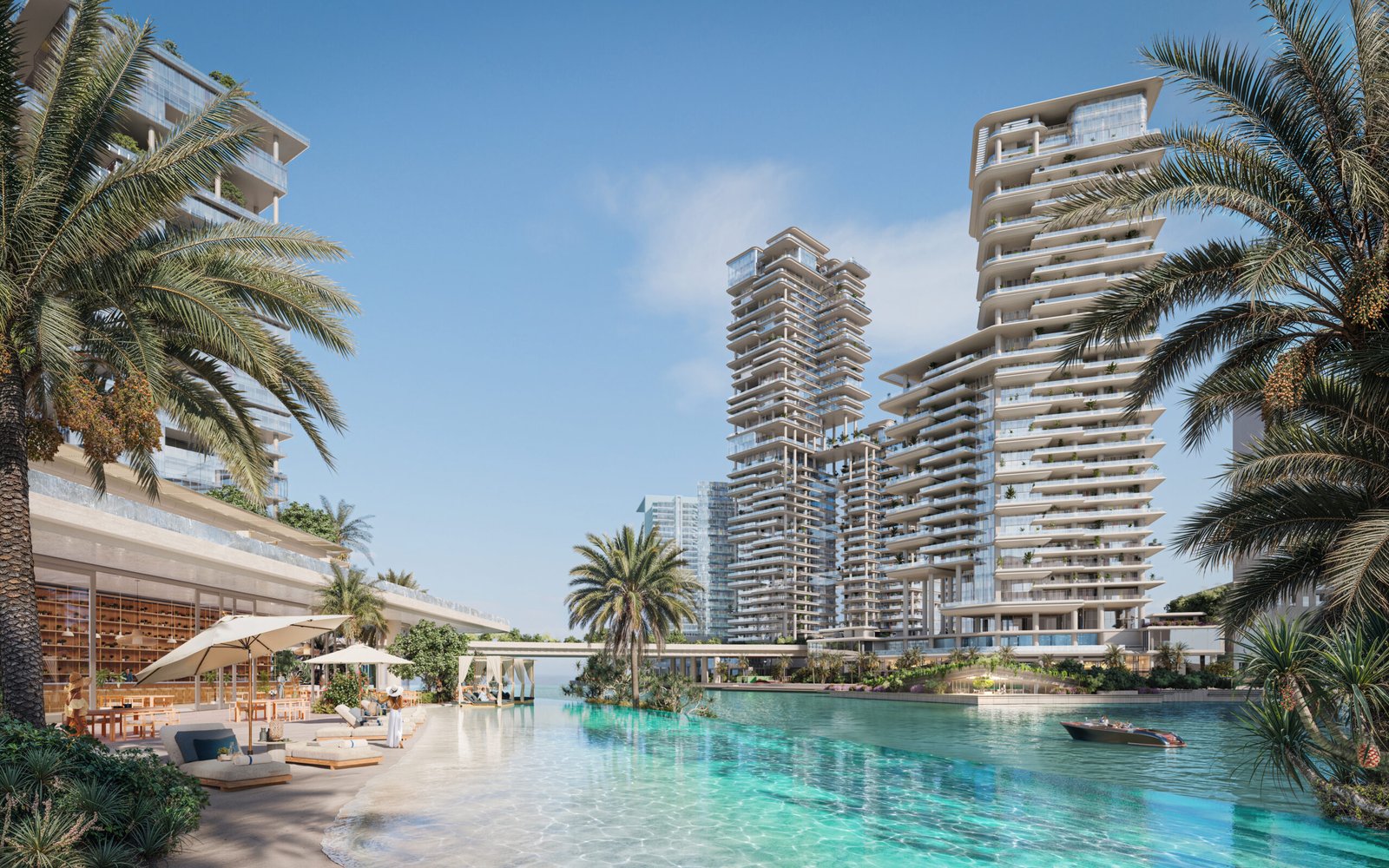 Waterfront towers with luxury apartments rising above a palm-lined turquoise lagoon and beach lounge