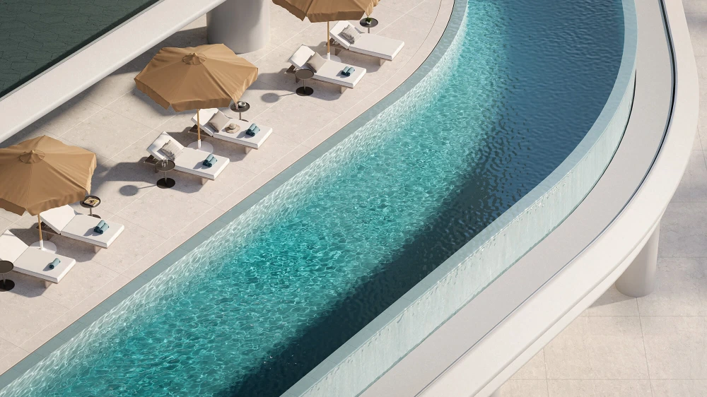 Curved infinity pool with sun loungers and beige umbrellas on a rooftop terrace at luxury apartments