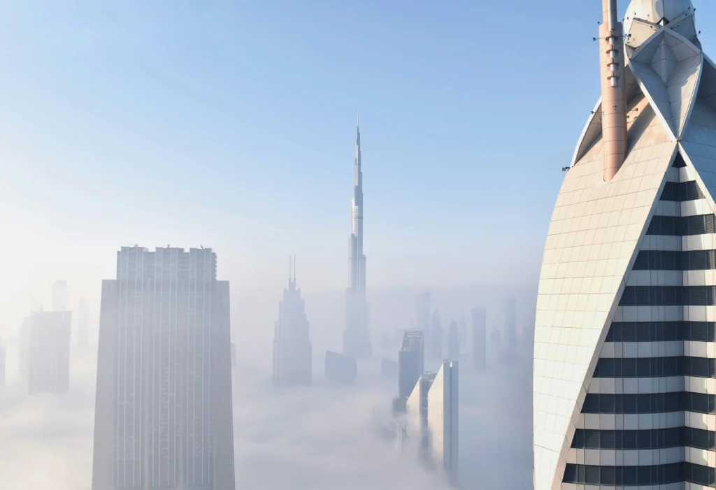 Dubai skyline with Burj Khalifa rising above morning fog